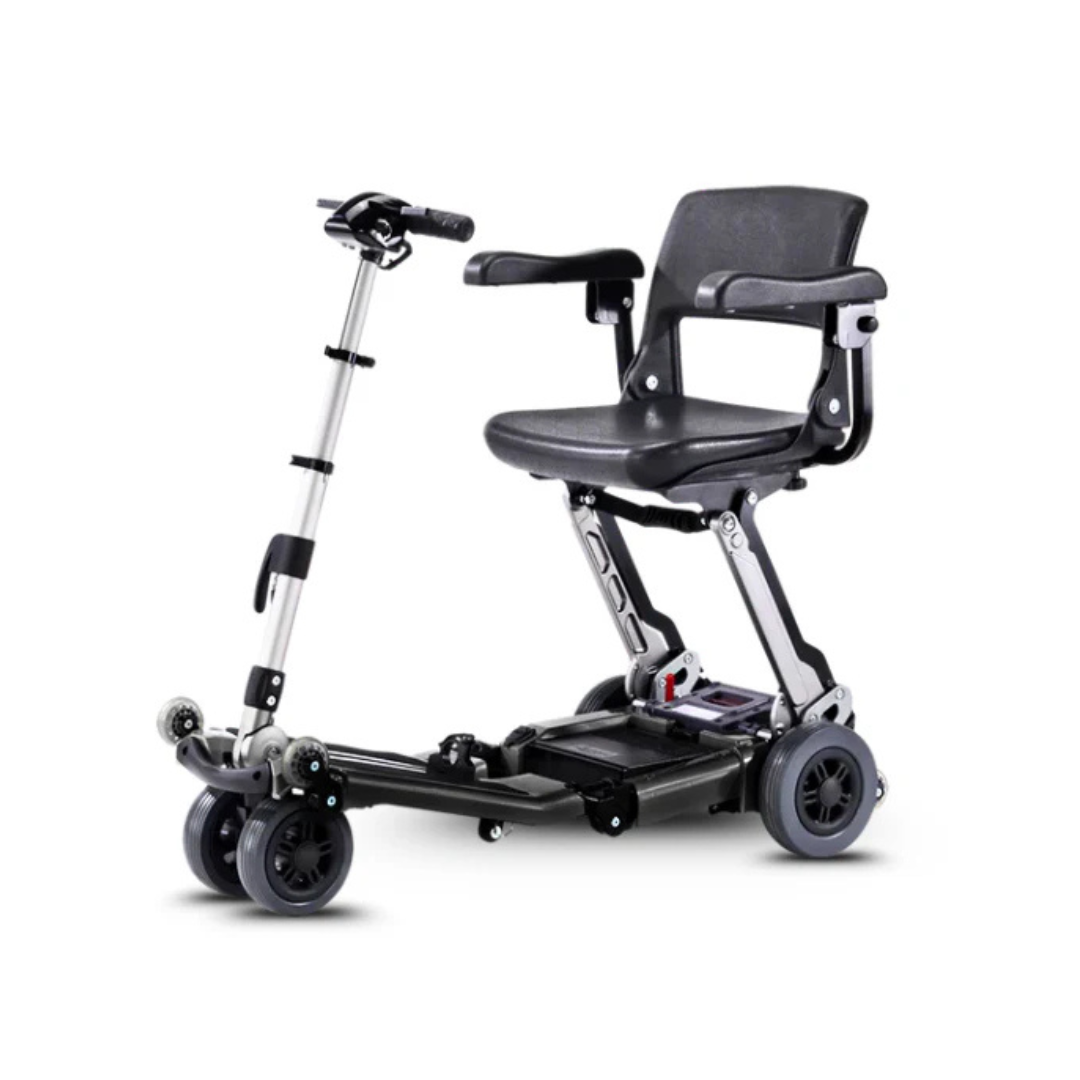 The FreeRider Luggie Elite Travel Scooter is a compact, airline-approved mobility scooter with a black seat, armrests, four wheels, and an adjustable handlebar. Foldable and perfect for travel, it's shown here on a plain white background.